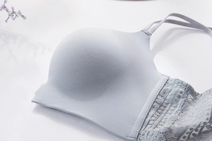 Detailed view of seamless light blue bra with delicate floral lace sides and thin straps
