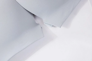 Macro shot of seamless light blue bra showing precision heat-press edges and elastic fabric