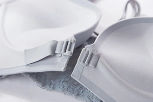Detailed macro view of seamless blue bra with front buckle closure and lace trim detail