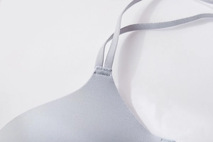 Detail of grey seamless bra showing reinforced stitching on the elastic shoulder strap