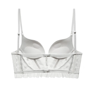 Detail view of the back of white French lace bustier with u-shaped back and mesh ruffles