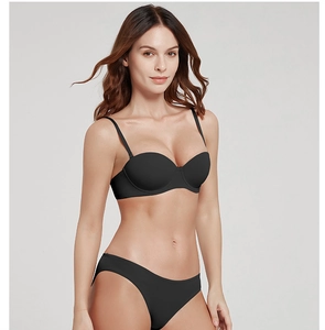 Detailed view of seamless black wireless push-up bra and matching bikini panty set