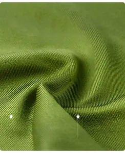 Macro shot of green lace satin bra fabric showing 90% polyester 10% elastane texture