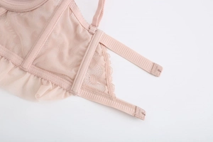 Detail of pink lace bra featuring breathable mesh fabric and elegant ruffle trim design