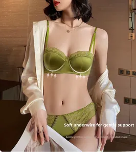 Detailed close-up of green satin and lace lingerie set with soft underwire support