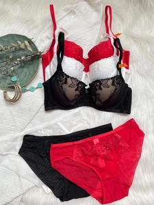 Flat lay showing detailed floral lace embroidery and sheer mesh on the lingerie set