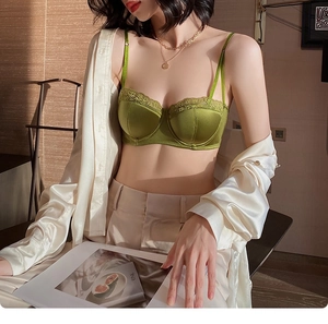Detailed close-up of avocado green satin lace bra with French style elegant embroidery