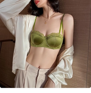 Detail of green satin bra featuring exquisite lace trim and adjustable shoulder straps