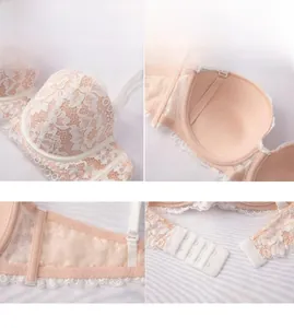 Detail view of pink lace bra showing floral embroidery, cup lining, and back closure