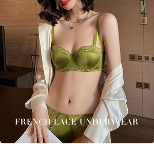 Detailed close-up of French green lace and satin lingerie set worn with a silk shirt