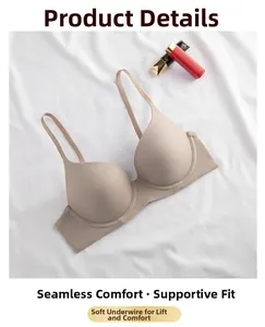 Detail view of seamless beige push-up bra with soft underwire on white textured cloth