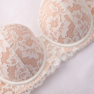 Elegant beige lace bra with floral patterns and underwire for supportive lift