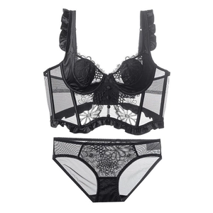 Detail of black French lace lingerie set featuring corset-style top with ruffle shoulder straps