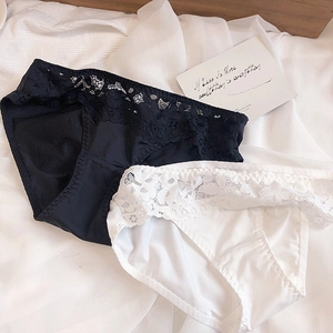 Detail of floral lace waistband on smooth black and white briefs with cotton crotch