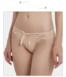 Detail of nude mesh underwear showing sheer tulle side panels and satin bow decoration