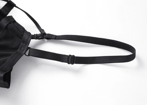 Detailed macro view of adjustable black elastic straps and fine mesh fabric of the bra