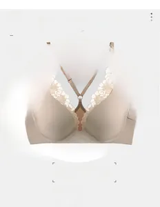 Close-up of thin breathable beige bra cups with delicate floral lace straps details