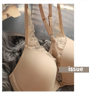 Close-up of beige lace bra featuring front closure and smooth cups with soft texture