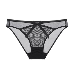 Detail of sheer black mesh panties with satin bow and decorative straps on white background