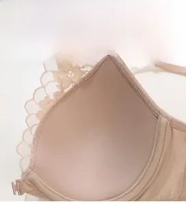 Close-up of thin breathable beige cups with delicate lace and soft sponge lining