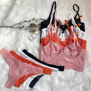 Detailed embroidery on unlined lace bra with matching thong set on white faux fur