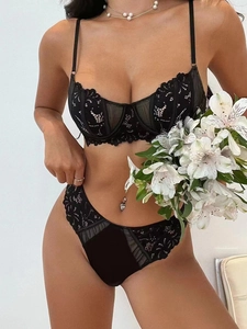 Close-up of black floral lace bra set with delicate mesh details and scalloped edges