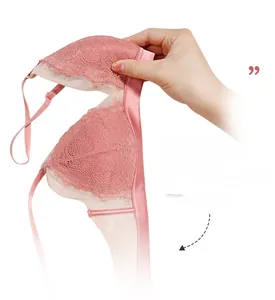 Flexible non-wired pink lace bralette shown being folded to demonstrate its softness