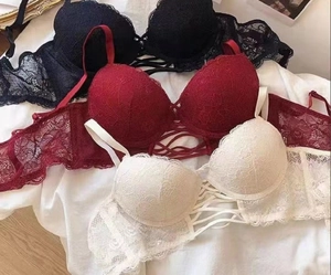 Detailed lace texture and cross-strap center of floral bras in black, red, and white