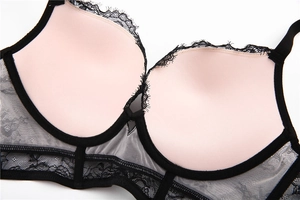 Close-up of black floral lace bra with pink cup lining and delicate eyelash lace trim