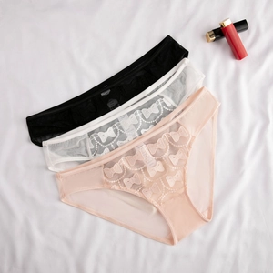 Detailed embroidery of three-pack mesh panties in black, white, and pink on white linen