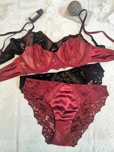 Detailed view of burgundy and black lace bras with satin fabric and underwire support