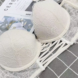 Detailed close-up of white floral lace bra with unique multi-strap镂空 hollow side wings