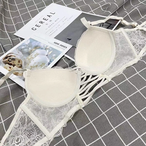 Close-up of white floral lace bra featuring hollowed-out elastic side straps and fine detail