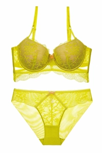 Close-up of fluorescent yellow lace lingerie set with floral mesh texture and details