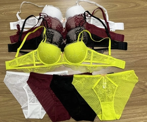 Detailed view of lace embroidery and mesh fabric on push-up bras in four colors