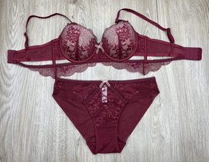 Flat lay of burgundy lace lingerie set featuring a push-up bra and matching panties