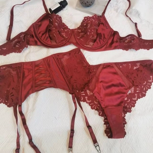 Three-piece French red lace lingerie set with underwire bra and garter belt