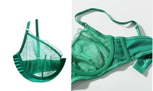 Detail view of emerald green lace bra showing sheer mesh fabric and underwire structure