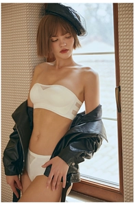 Detailed view of seamless white strapless bra and matching panties set with sheer mesh panels