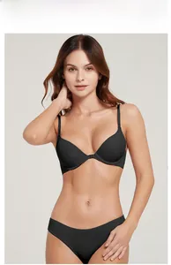 Detail view of seamless black front-closure bra set with matching briefs on model
