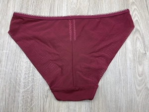 Detailed flat lay of wine red lace mesh panties with scalloped edges and breathable fabric