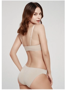 Seamless beige deep V bra set with adjustable straps and soft cups on model