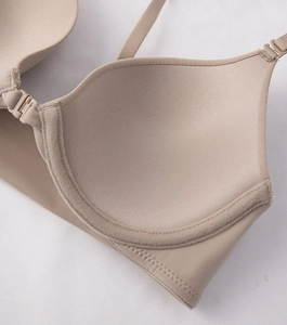 Detail of beige push-up bra featuring front closure and breathable inner cup texture