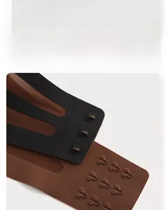 Detail view of seamless back closure with three-row metal hook-and-eye buckles