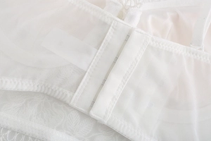Detail of the white lace bra back closure featuring breathable mesh and fine stitching