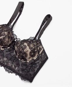 Close-up of black floral lace embroidery detail on elegant push-up corset style bra set
