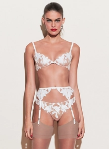 Detailed view of white floral lace embroidery on thin mesh three-piece lingerie set