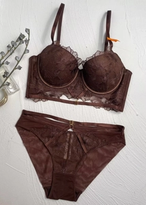 Close-up of brown lace lingerie set with floral embroidery and strap detailing