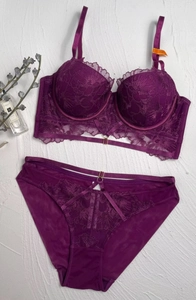 Detailed view of dark purple lace lingerie set with floral embroidery and cutout straps