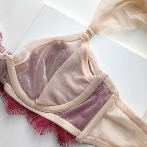 Detail of burgundy eyelash lace and nude breathable mesh with gold metal hardware